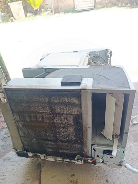 Heavily clogged window air conditioner awaiting a complete service overhaul.