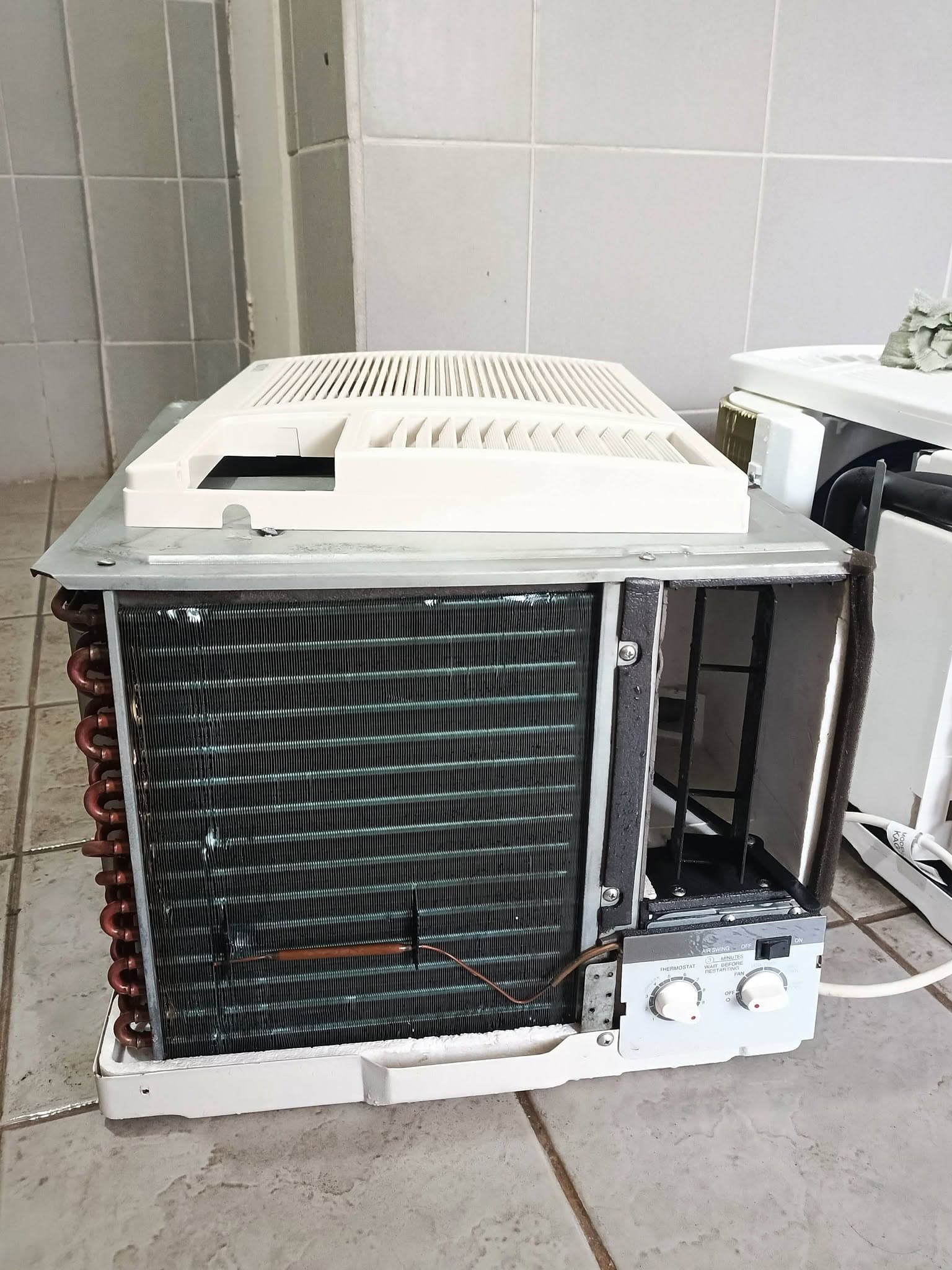 Completed deep-cleaned window air conditioner ready for reassembly.