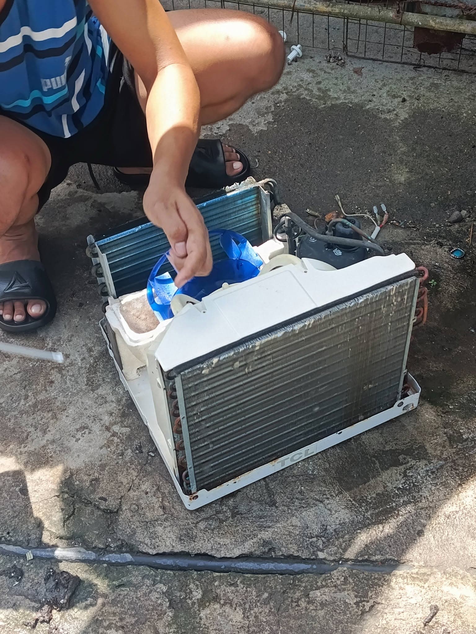 Technician inspecting the cleaned blower assembly and coils before reassembly.