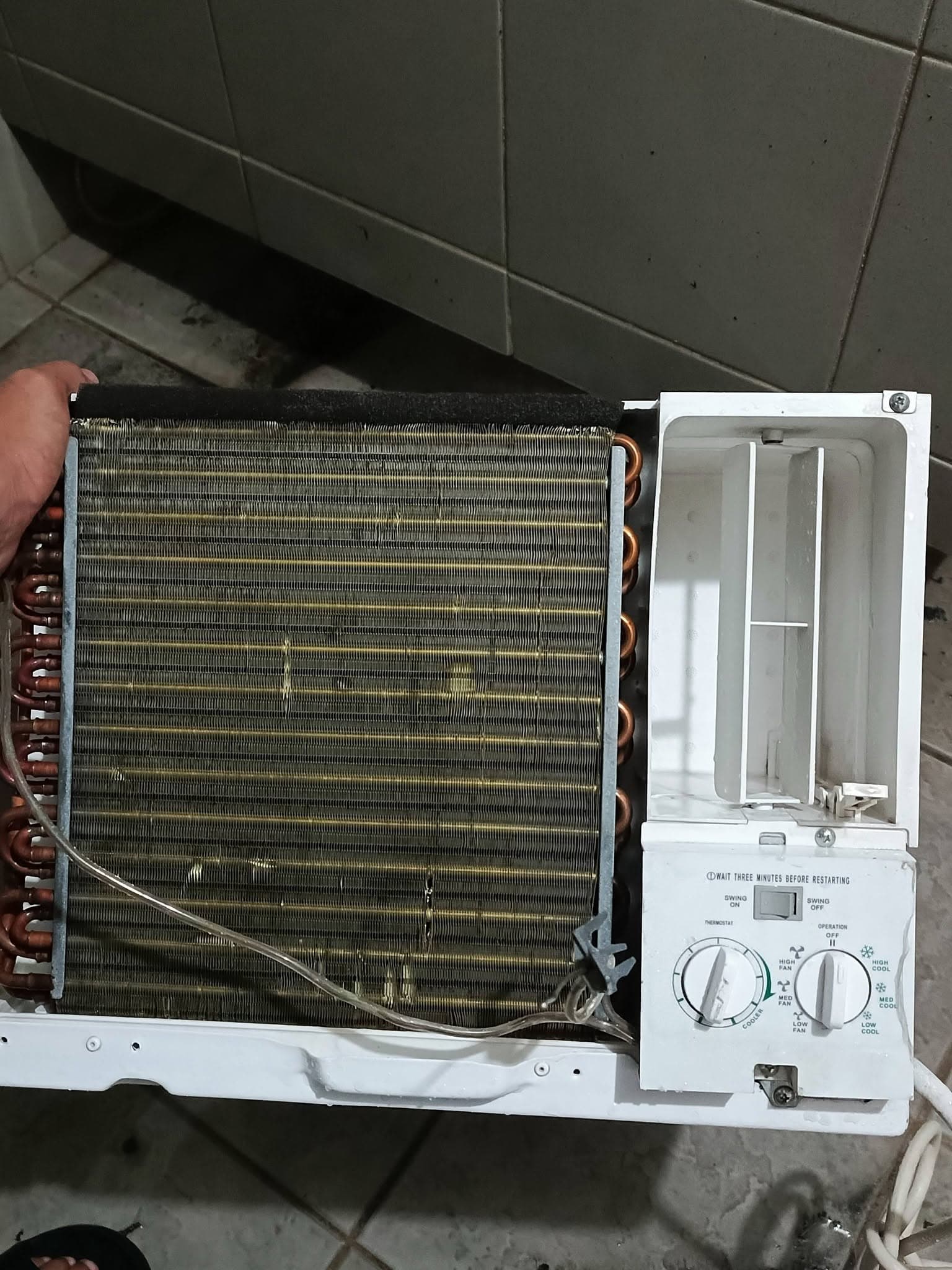 Cleaned window air conditioner with restored coil, air channel, and control panel.