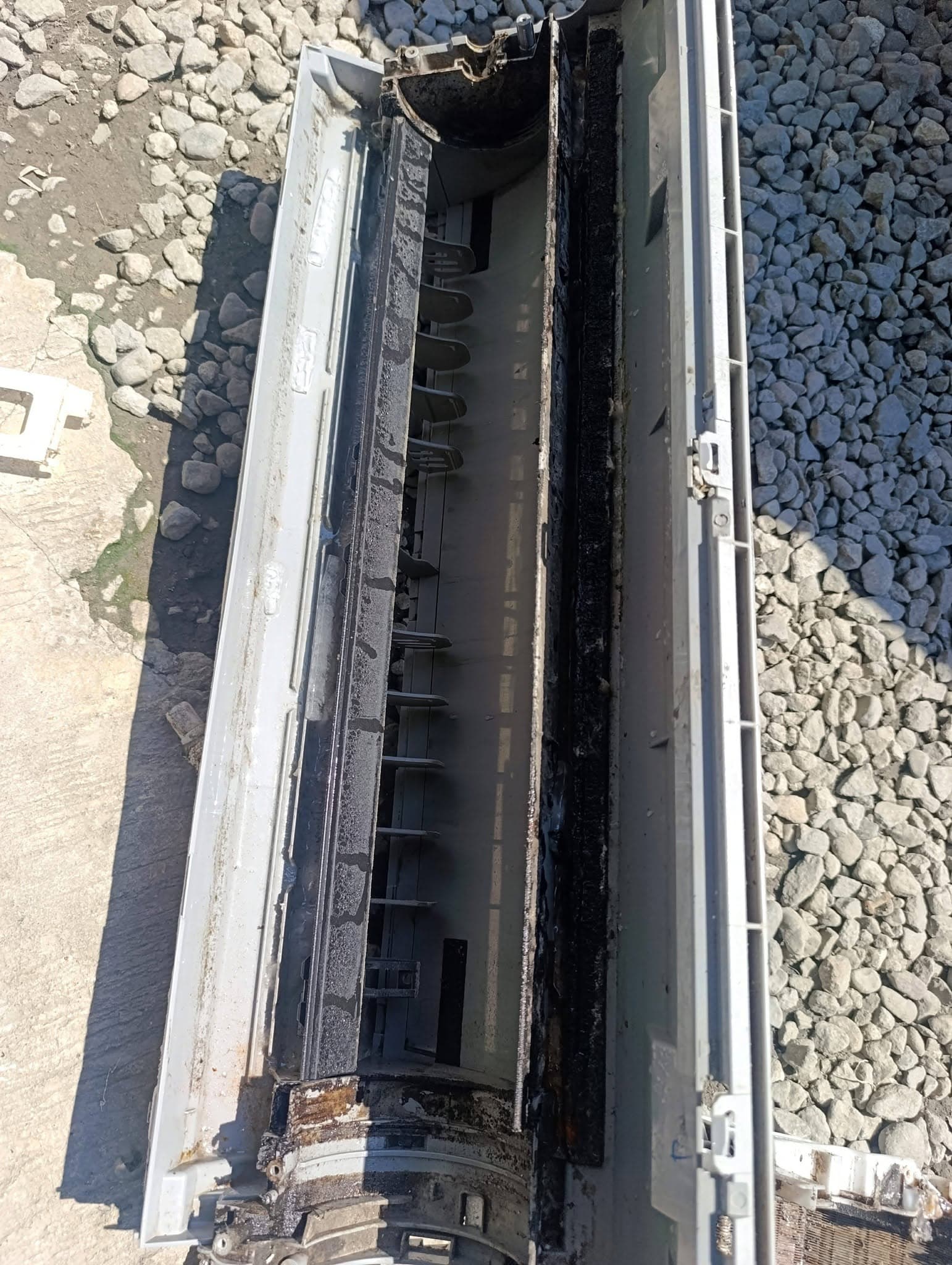 Close view of heavy grime inside the split-type indoor unit housing.
