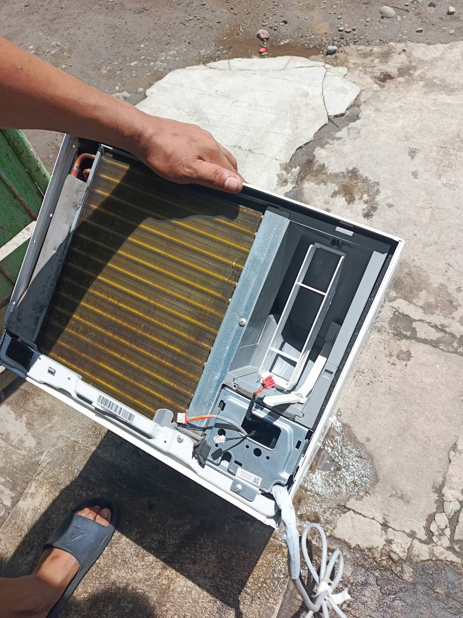 Cleaned compact window air conditioner ready for electrical reconnection and final reassembly.