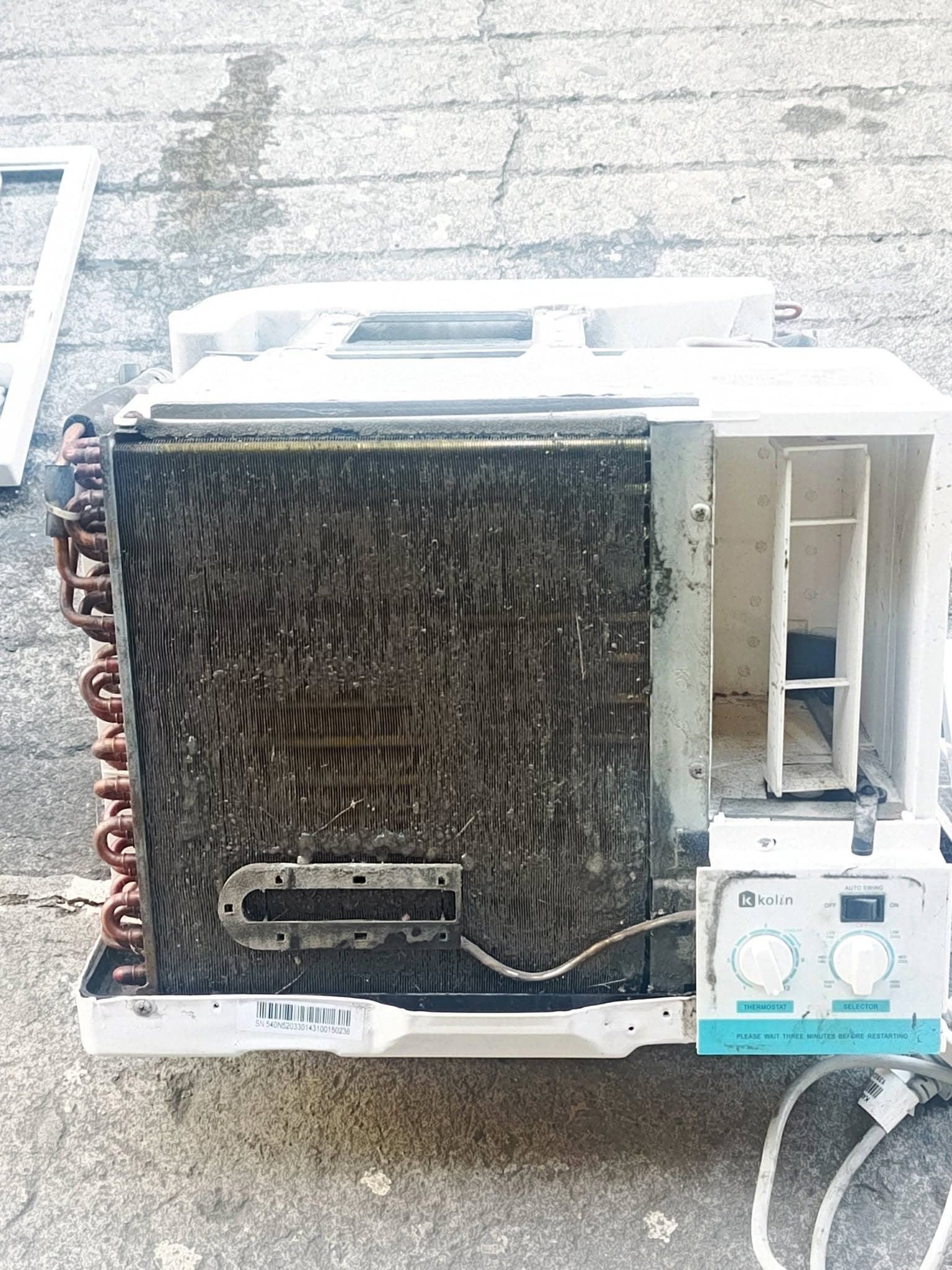 Kolin window-type air conditioner opened to reveal a severely clogged evaporator coil.