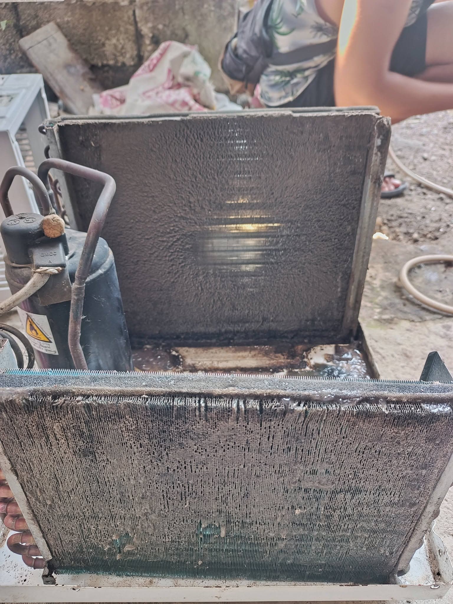 Close view of severely clogged evaporator and condenser coils before restoration.