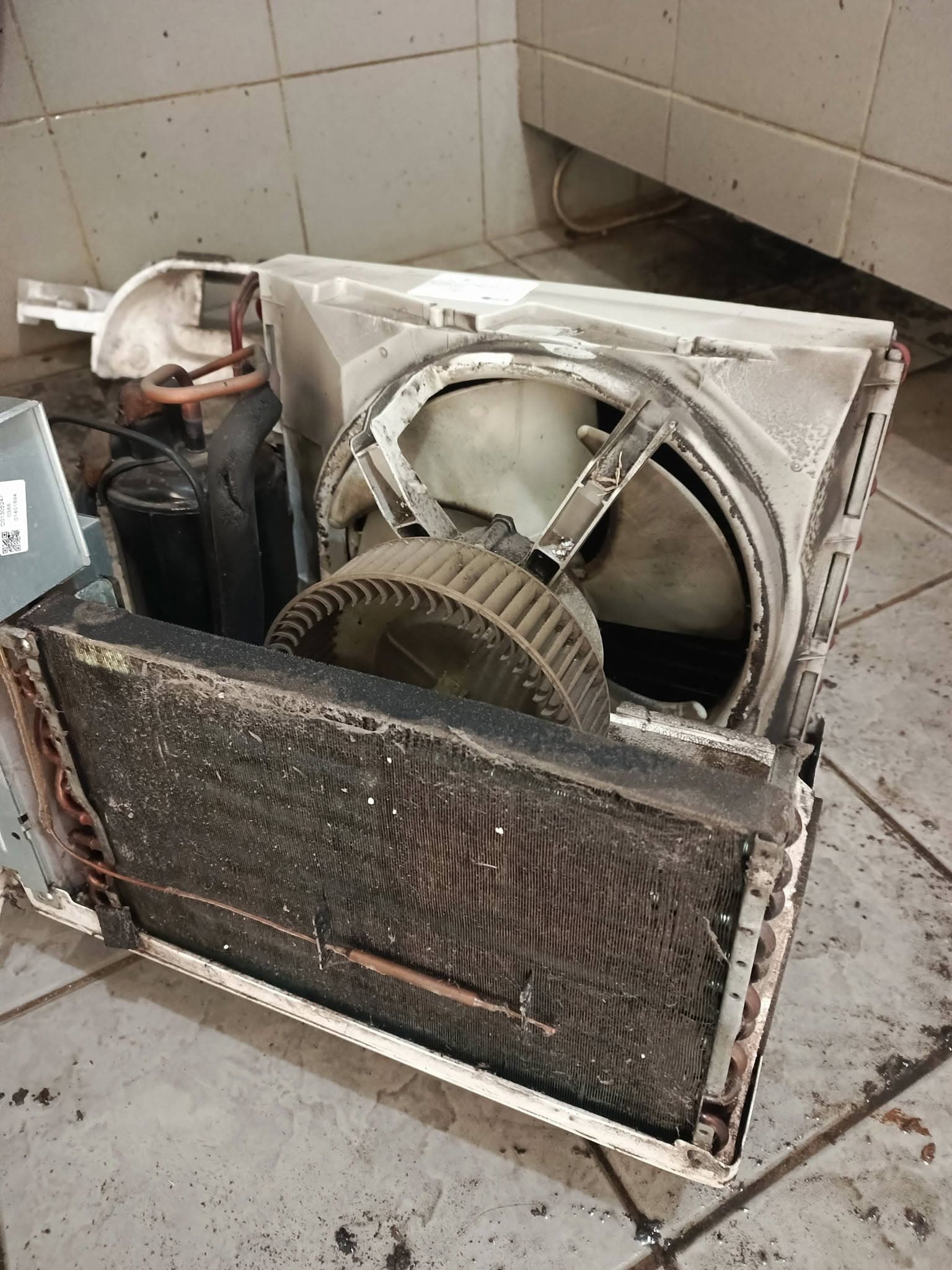 Dirty window air-conditioning unit prepared for pressure washing.