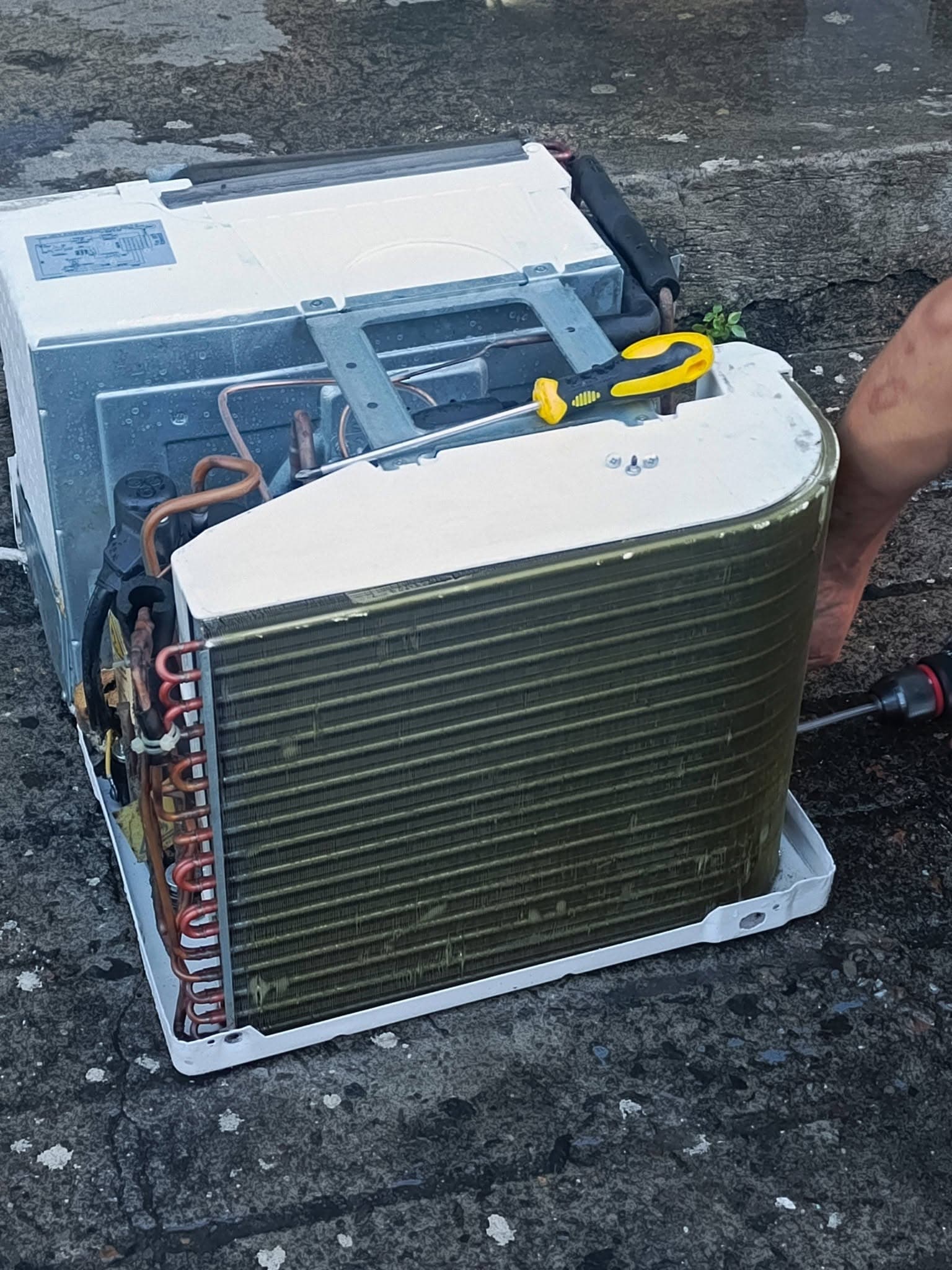 Cleaned window air conditioner coil and chassis prepared for final reassembly.