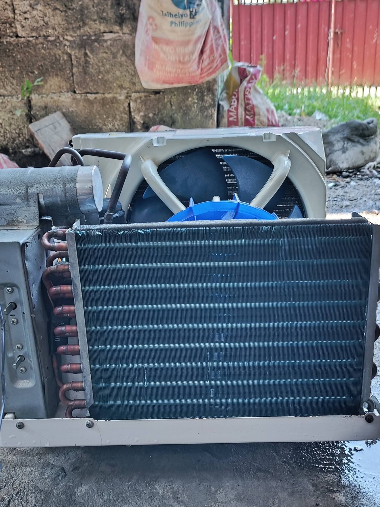 Restored window air conditioner with clean condenser fins and fan assembly.